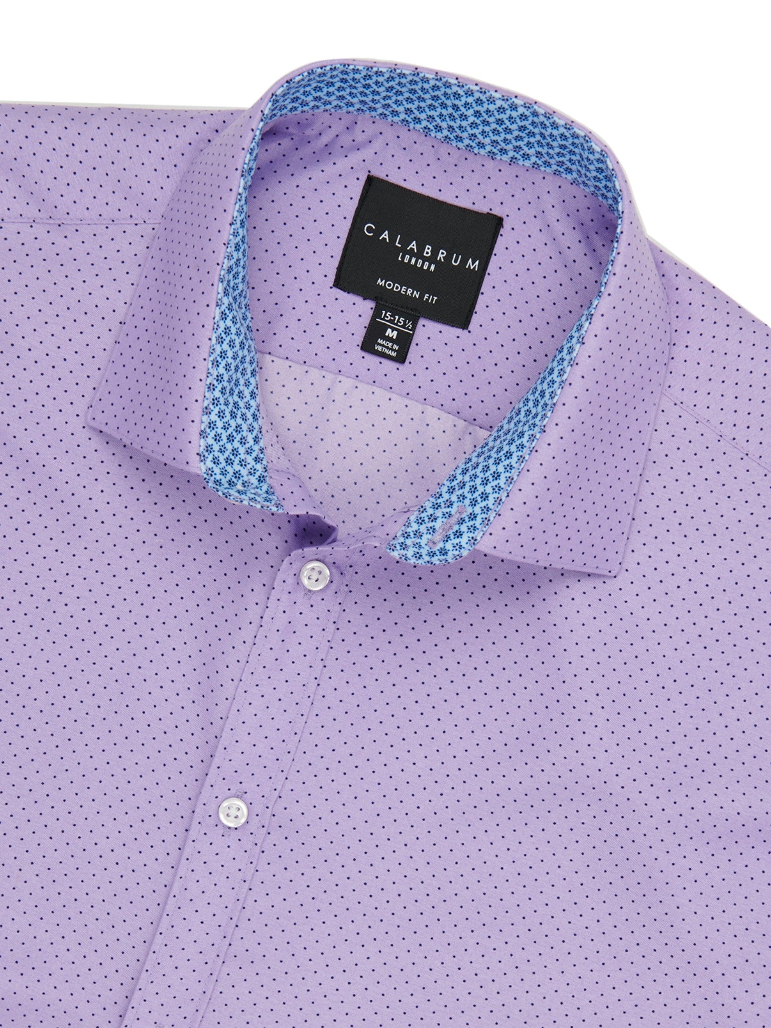 Close-up of a purple dress shirt with a Calaerum label on a white background