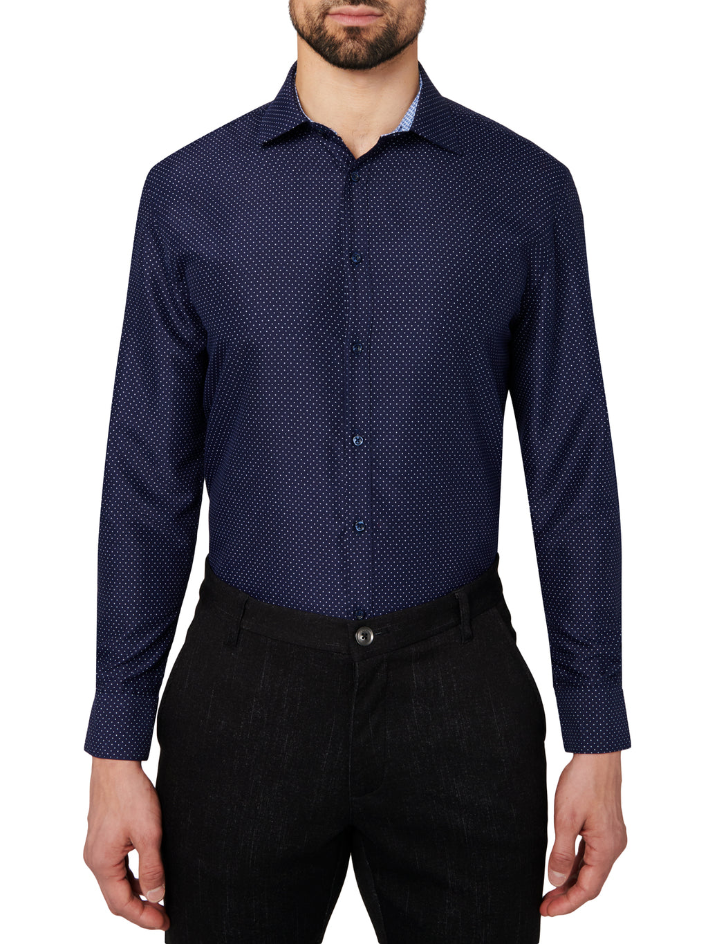 Man wearing a navy patterned dress shirt and black pants on a white background