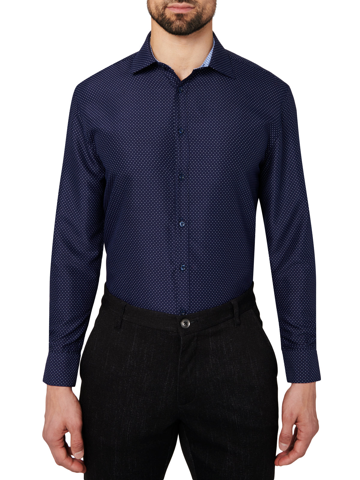 Man wearing a navy patterned dress shirt and black pants on a white background
