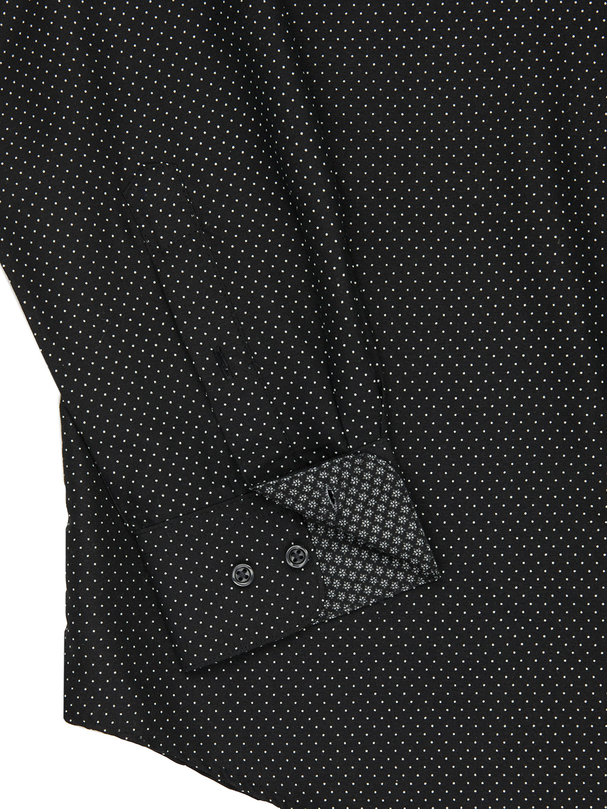 Close-up of a black patterned shirt with a button and cuff detail.