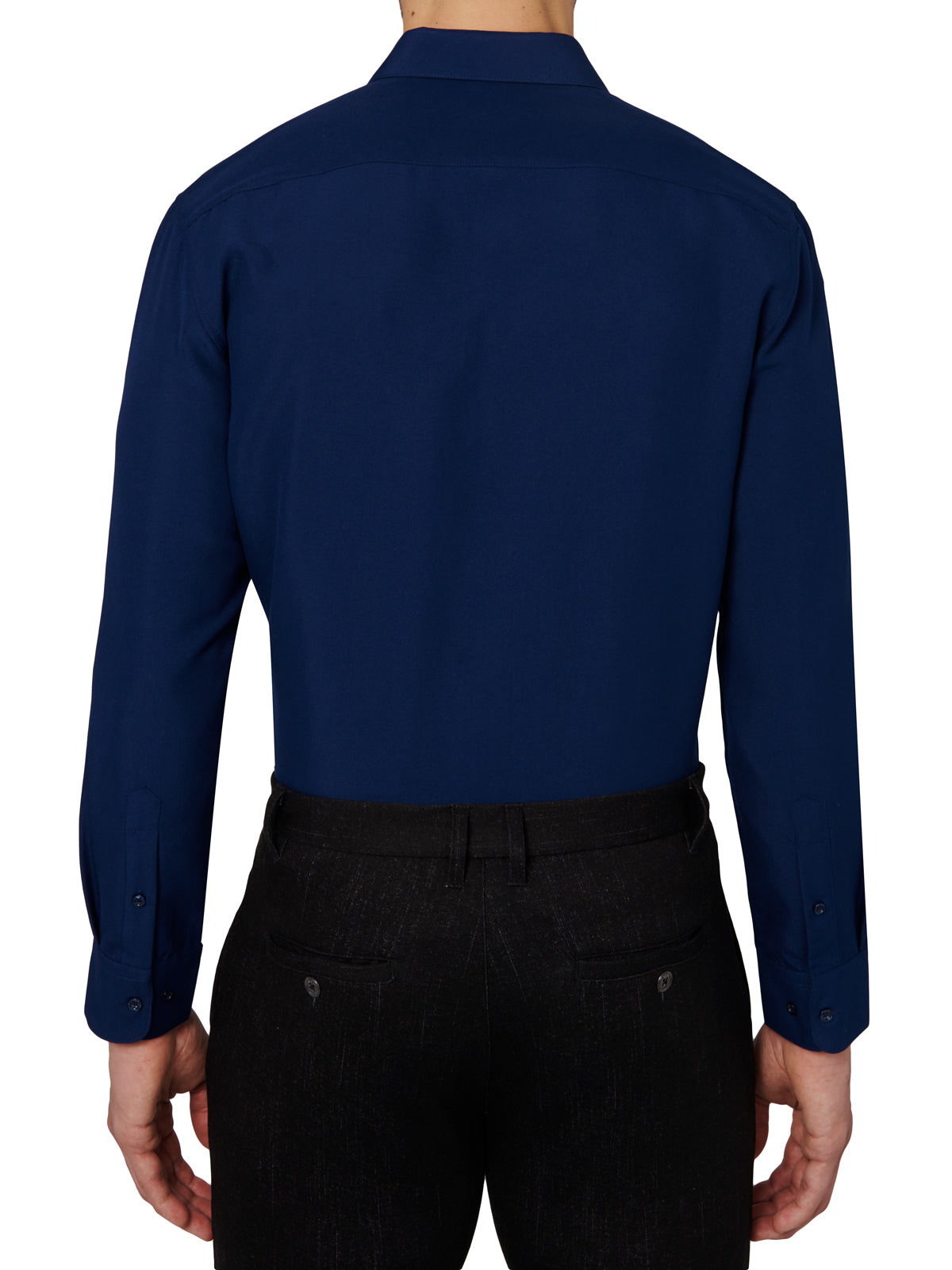 Person wearing a navy blue dress shirt and black pants on a white background