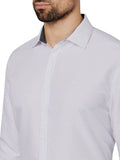 Close-up of a patterned shirt worn by a person on a white background