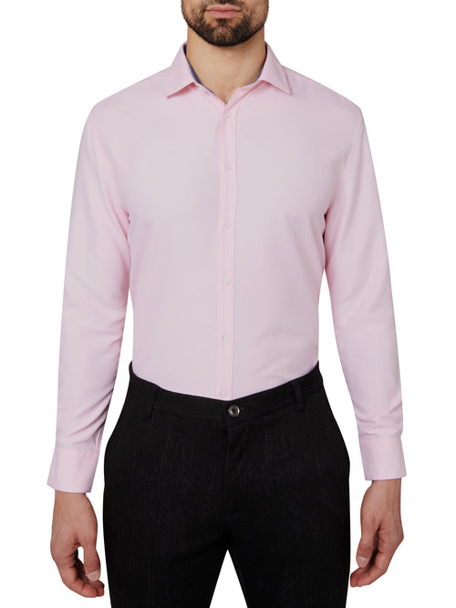 Man wearing a light pink dress shirt and black pants on a white background