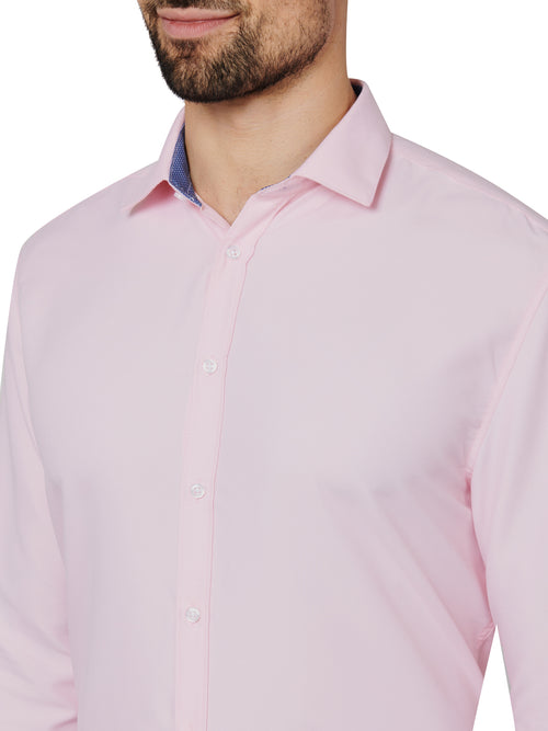 Pink dress shirt worn by a person on a white background
