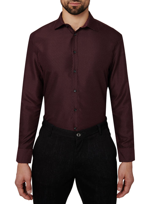 Man wearing a maroon patterned dress shirt and black pants on a white background