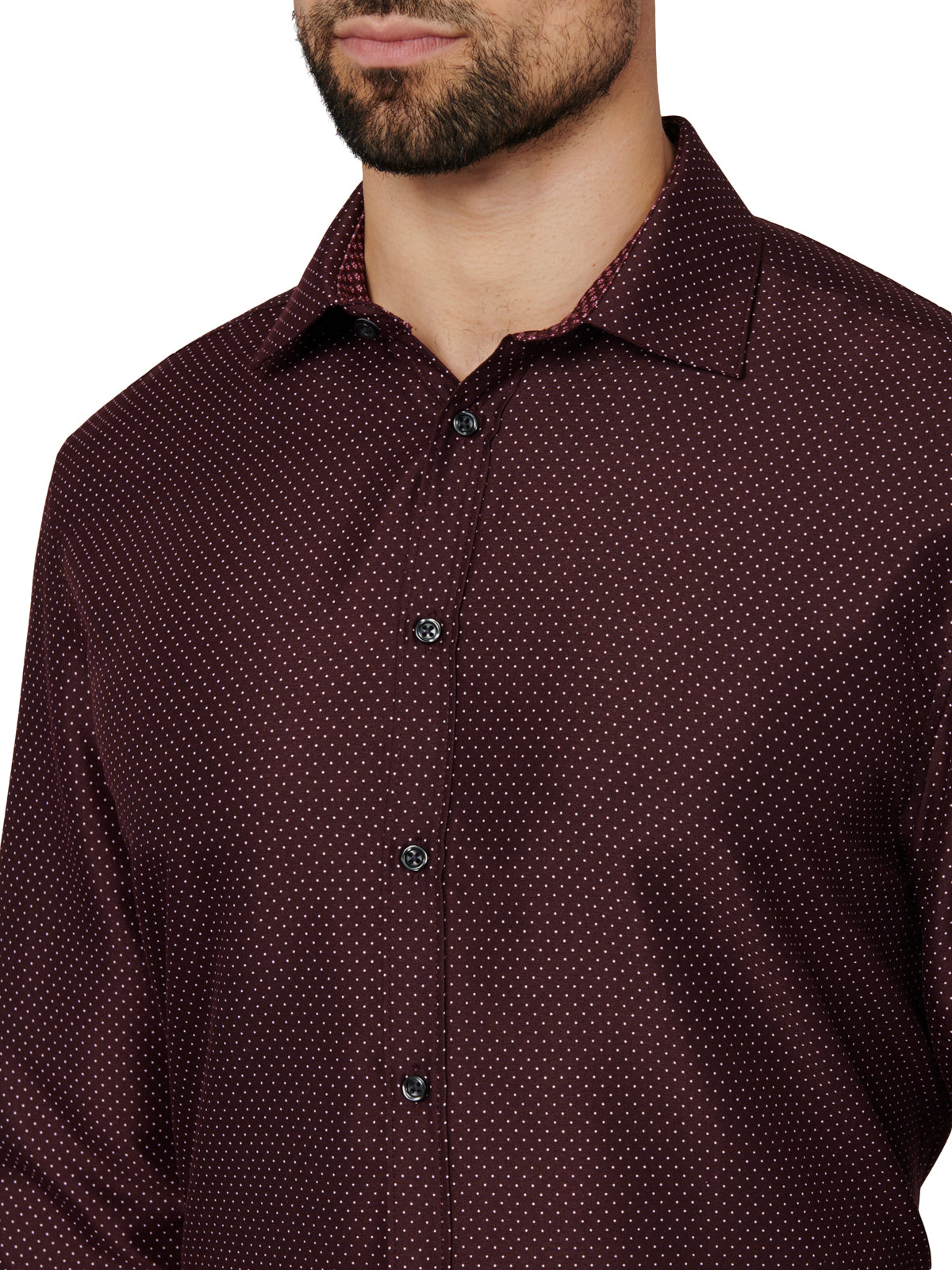 Man wearing a maroon patterned shirt against a white background