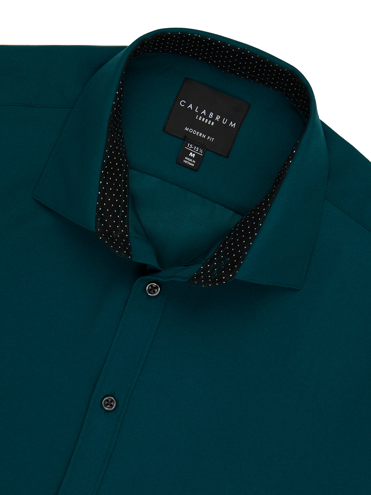 Teal shirt with black polka dot trim and Calvium label on a white background
