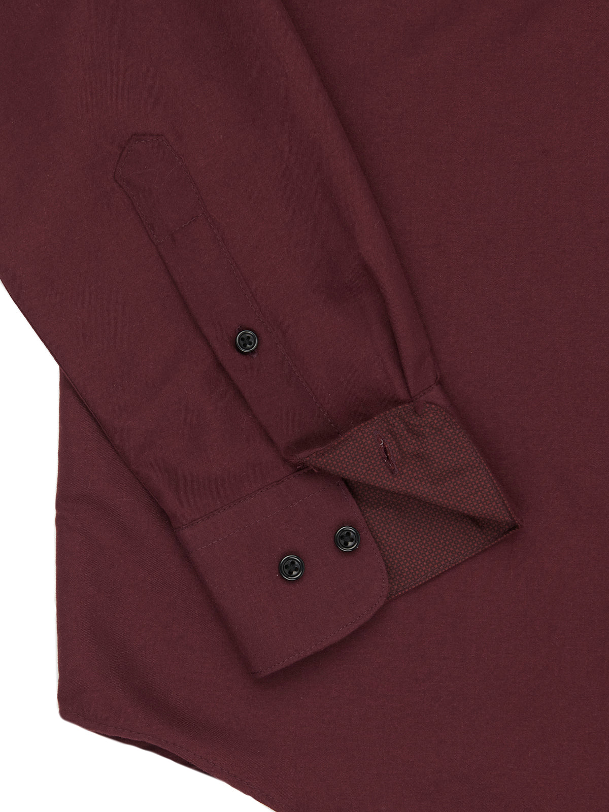 Close-up of a maroon shirt with button details on a white background