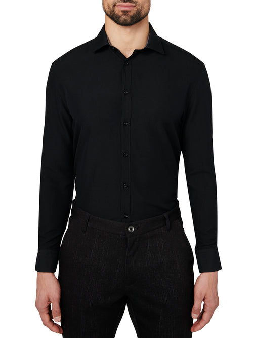 Man wearing a black dress shirt and pants on a white background