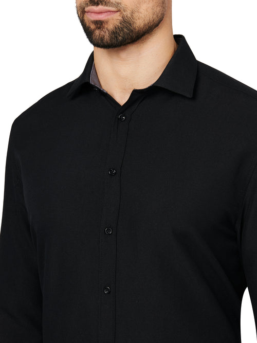 Black button-up shirt worn by a person on a white background