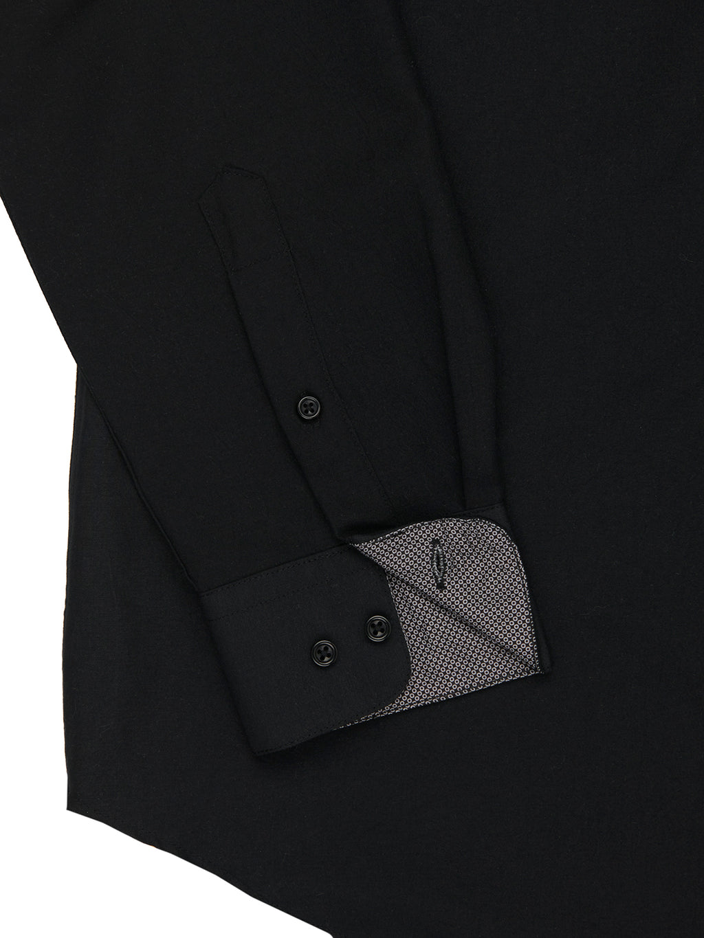 Close-up of a black shirt with button details on a white background