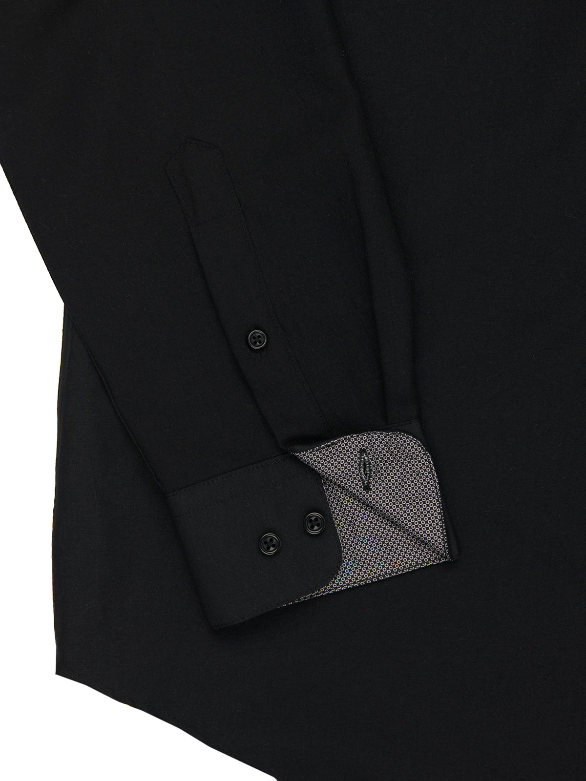Close-up of a black shirt with button details on a white background